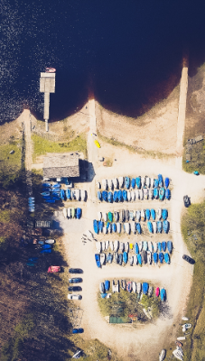 An overhead shot of boats on the ground by the water at Erwood Reservoir.