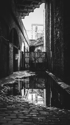 A black and white shot of the arches on Duke Street, an old cobbled back street in Castlefield, Manchester